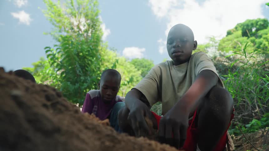 A child is digging in the dirt