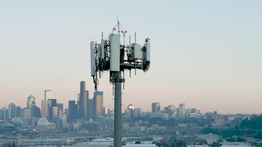 Subtle orbit around a 5G transmission antenna with the skyline of Seattle in the background
