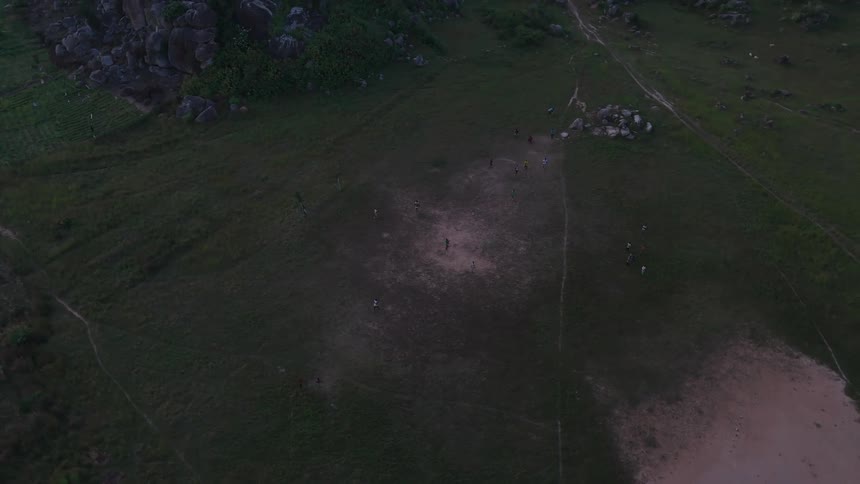 Aerial shot of a vast field and children running