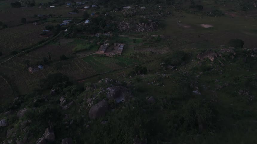 Aerial view of a community in a rural area surrounded by mountains