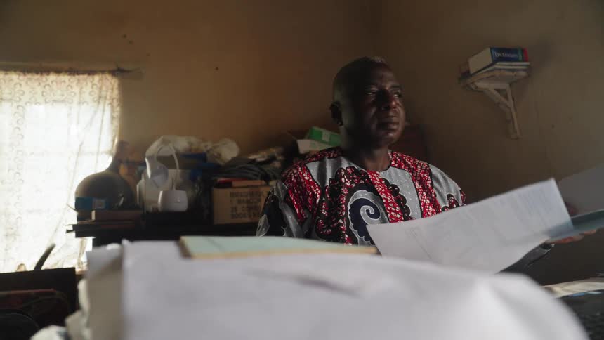 A clip of a man reading in the office