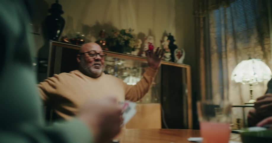 One of four friends playing a card game wins the hand