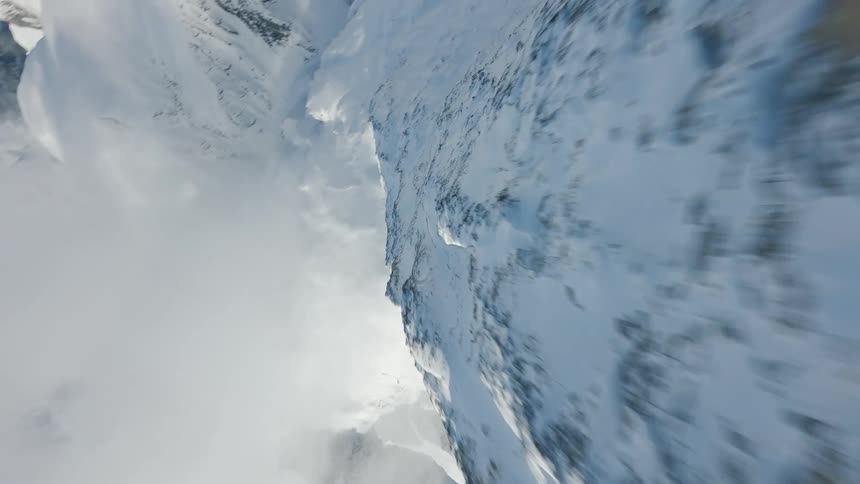 Drone Shot Over Snow-Capped Peaks Into a Majestic Swiss Valley