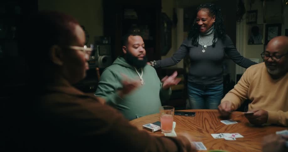 A clip of a family playing a card game indoor