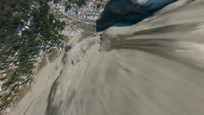 FPV Drone Flight Through Trees, Descending a Snowy Mountain Cliff in Switzerland