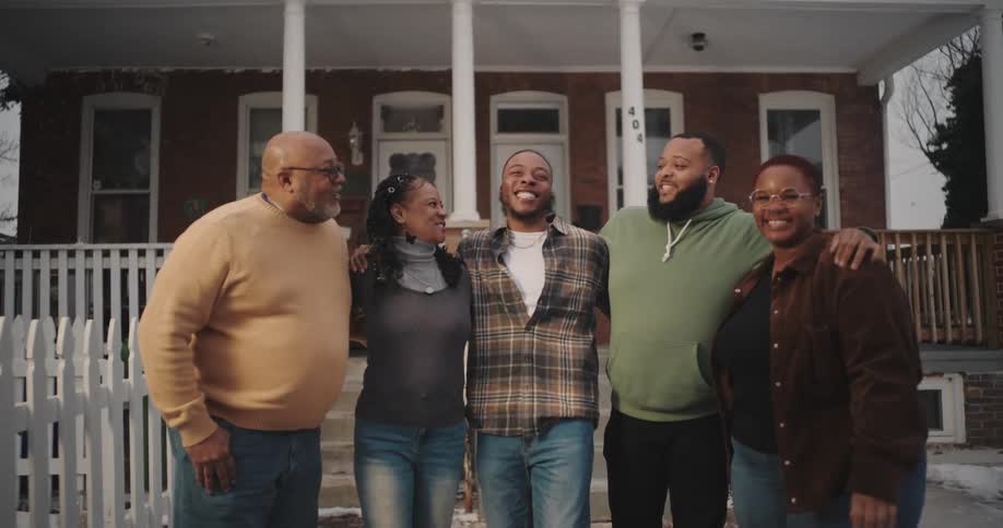 A footage of a family standing outside the house