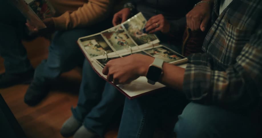 People sitting looking at photo albums