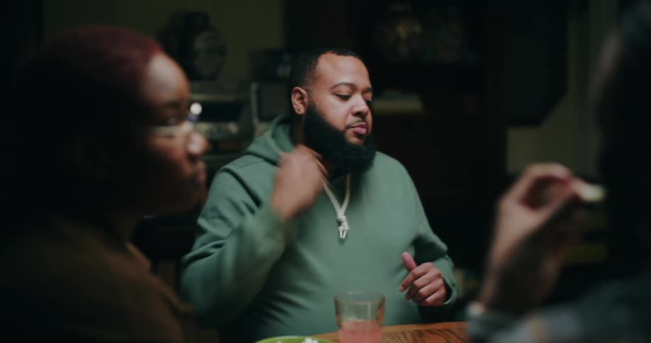 Small group of people sitting at a table playing games and drinking