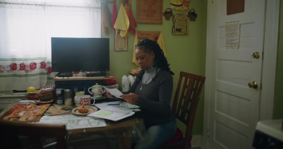Woman sitting at desk and analyzing a paper document