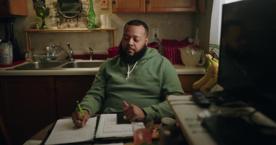 A man is writing notes on a piece of paper
