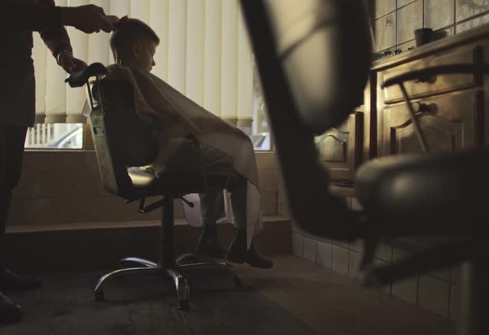 Barber cutting a boys hair