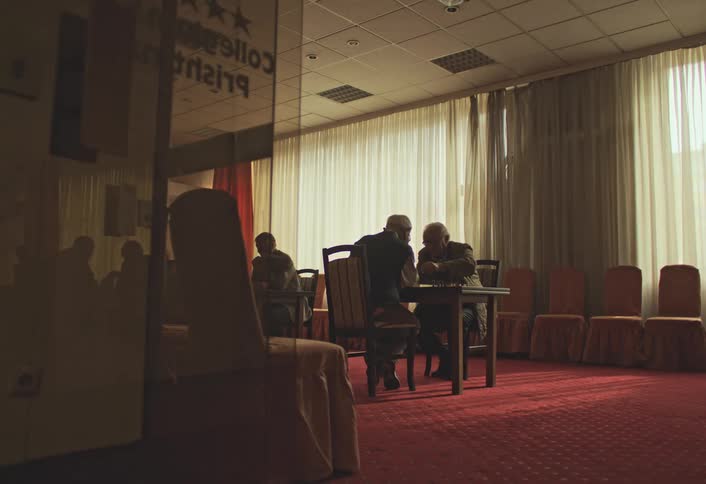Men are playing chess at the table