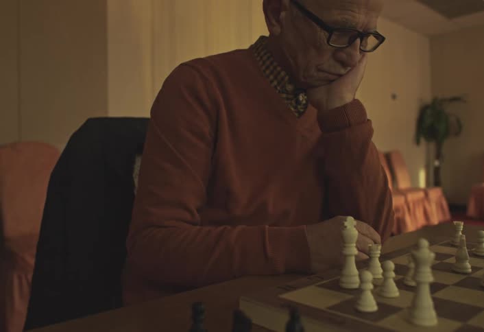A footage of a man playing chess