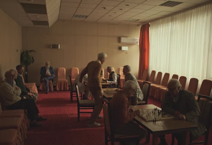 People are playing chess in the retirement home