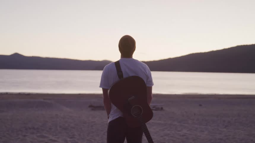 A footage of a male standing at the sea side