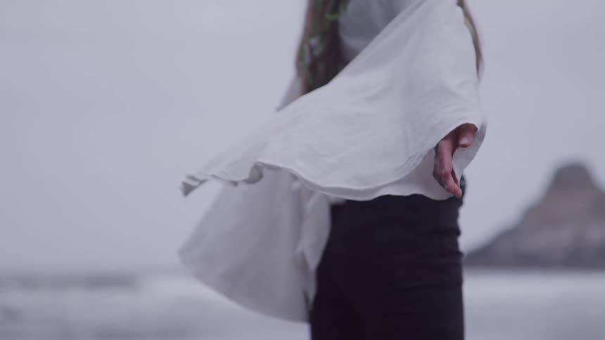 A footage of a person standing outdoor with arms stretched