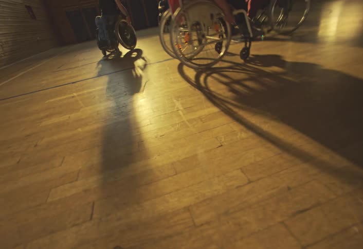 People are playing basketball on wheelchairs