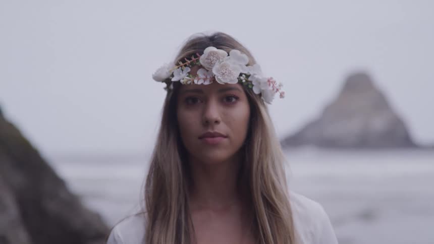 A woman lifts her head on the beach