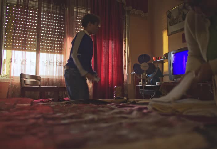 A footage of a teenager playing video games in the room