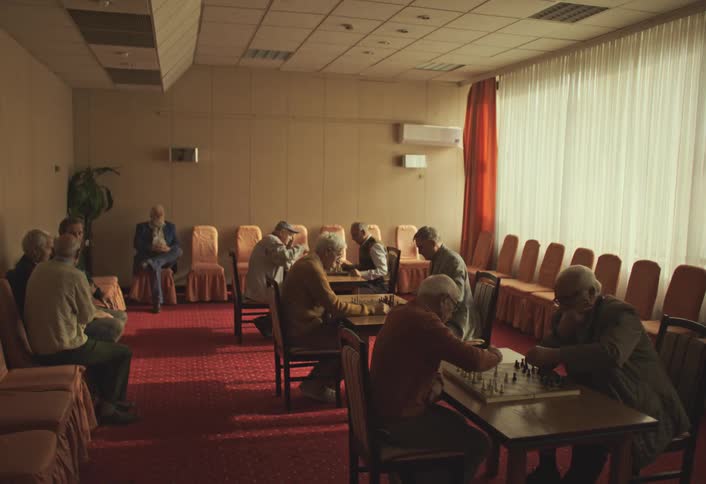 A footage of elderly men playing chess indoor