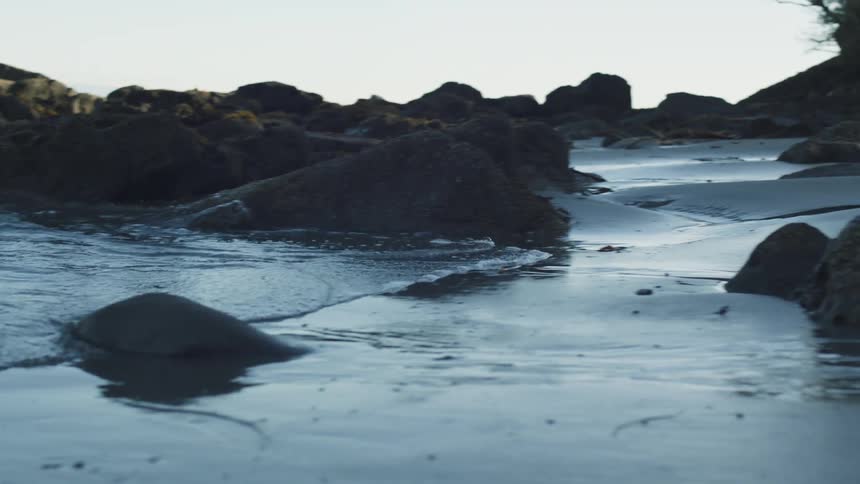 A wave climbs on the sand of he beach