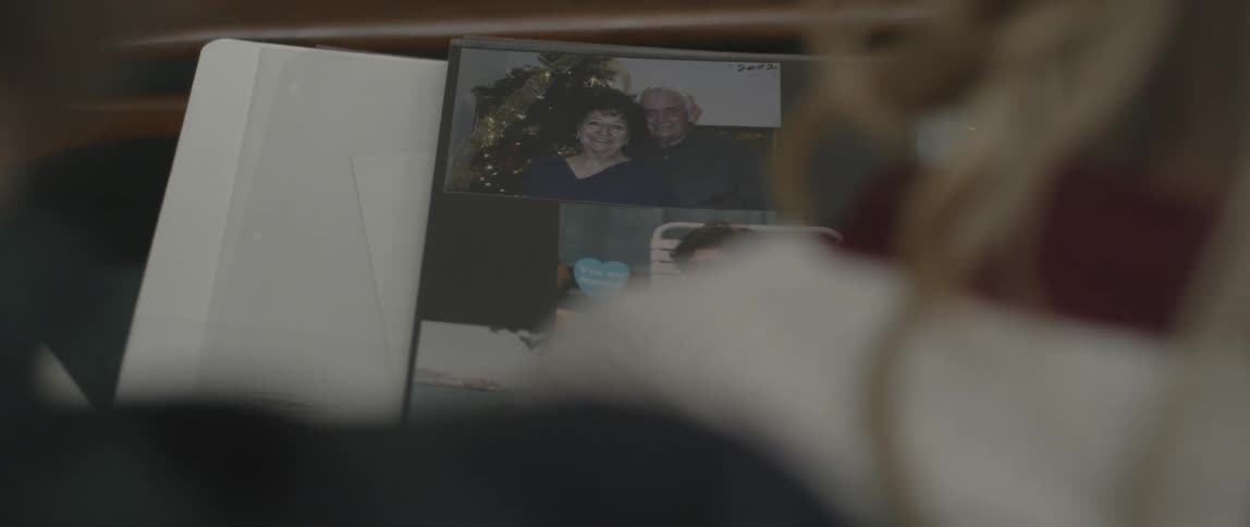 A man and woman look at photo albums