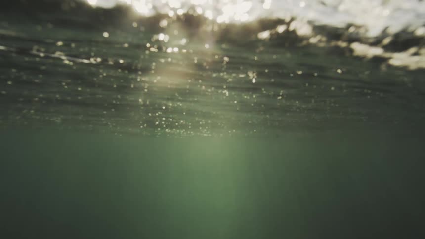 Underwater view of an ocean with sunlight reflecting off it