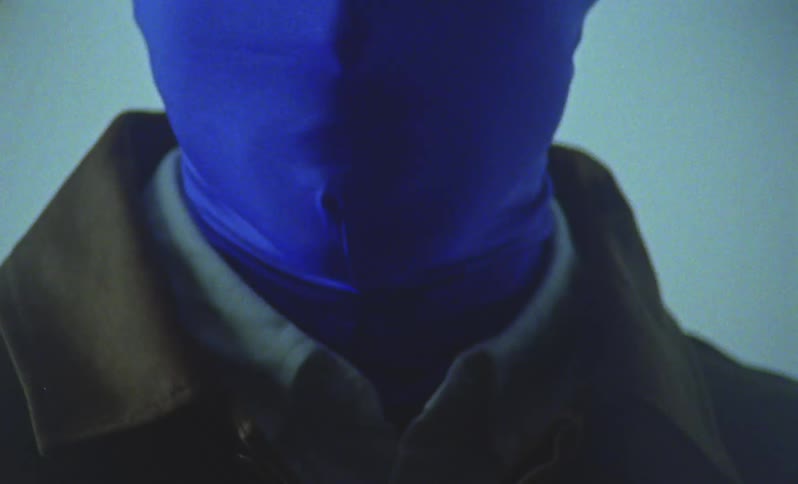 Face of a person with a blue hood