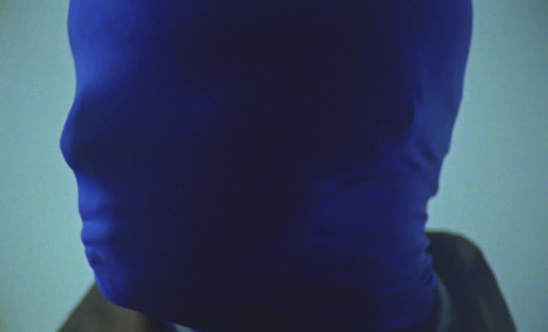 A man is earing a blue mask and gloves