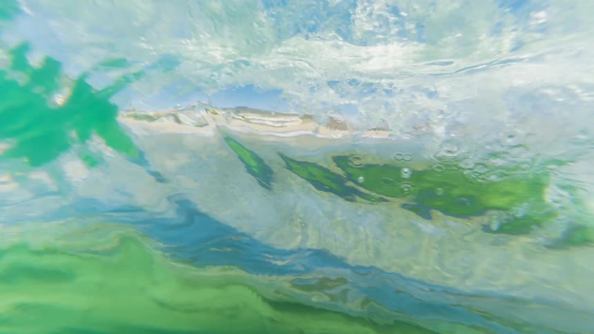 The turbulent surface of a wave seen from underwater