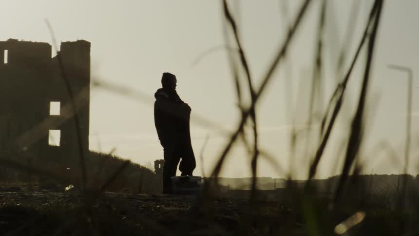 Silhouette of a static person observing in a natural location