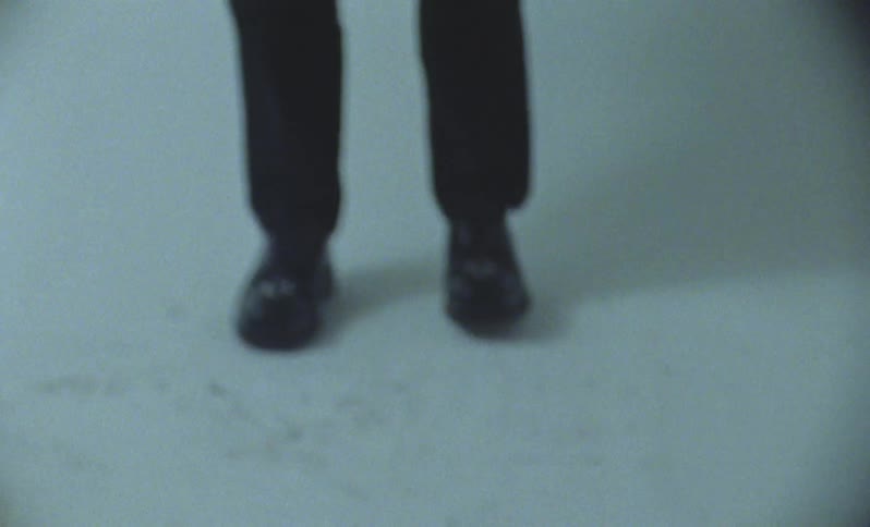 Person wearing black shoes and black pants moves through dance steps
