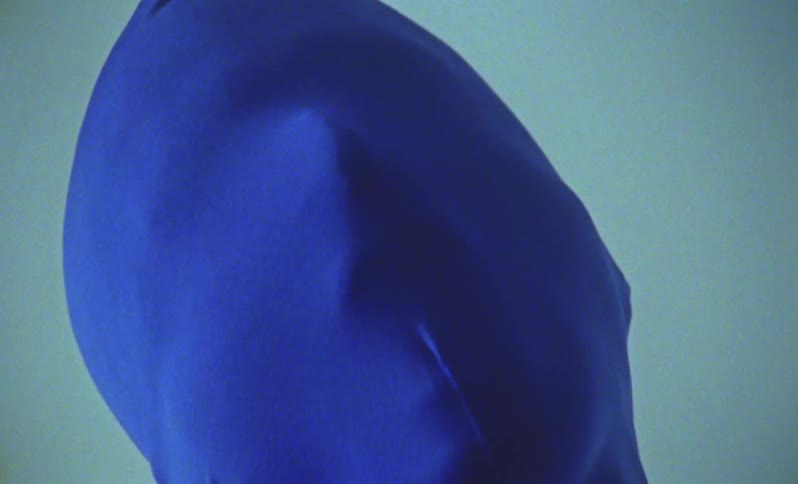 Closeup of a persons face covered by a blue hood