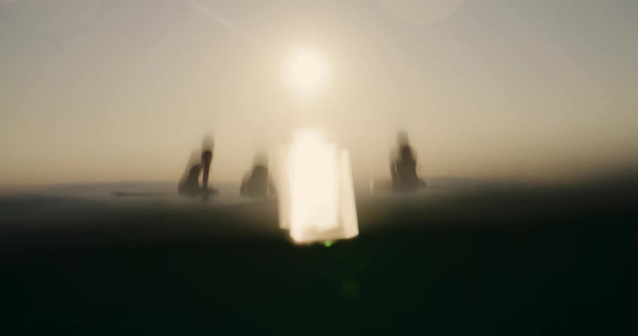 Women are in the water at dusk