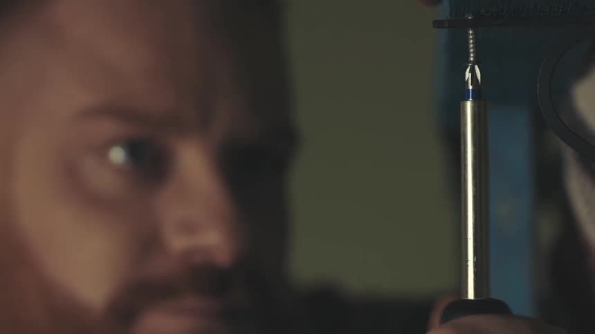 Portrait of a man unscrewing