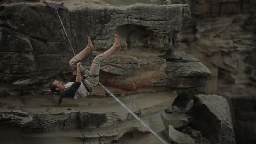 A man loses his balance on a tightrope
