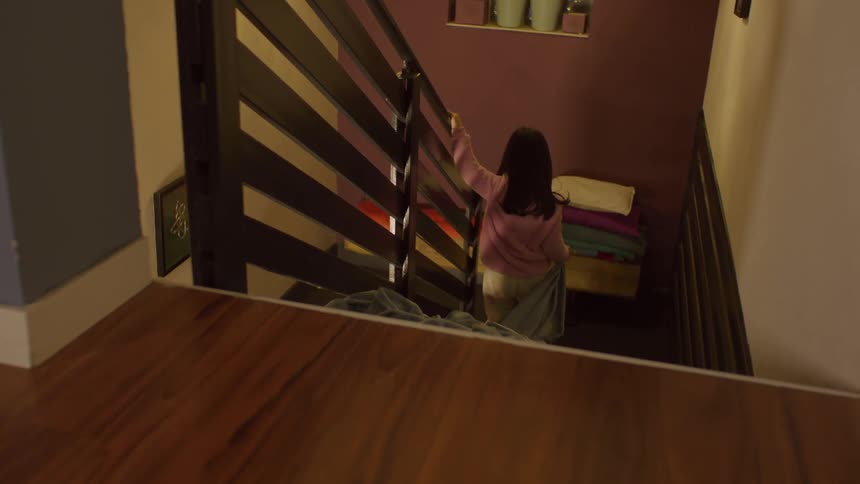 Little girl walking down the stairs dragging her blanket