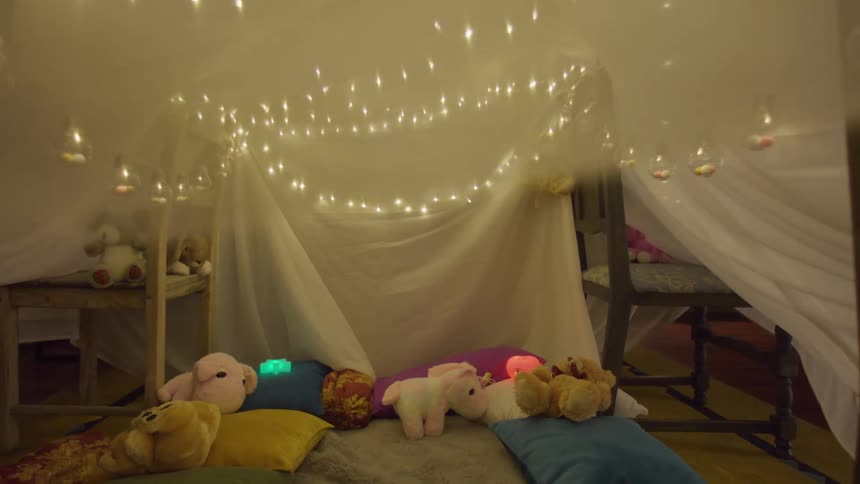 Pillows and teddy bears under a sheet placed on chairs