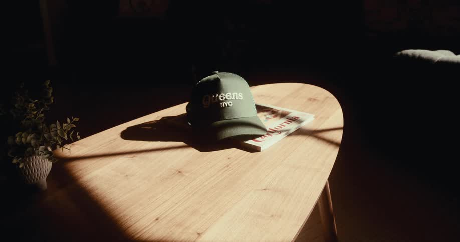 Sunlight enters a room revealing a cap on a table