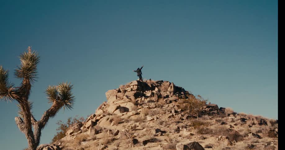 Person on top of a ruin with arms outstretched