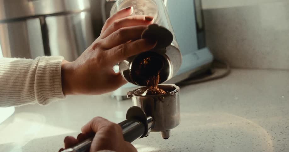 Coffee powder being poured into a handle