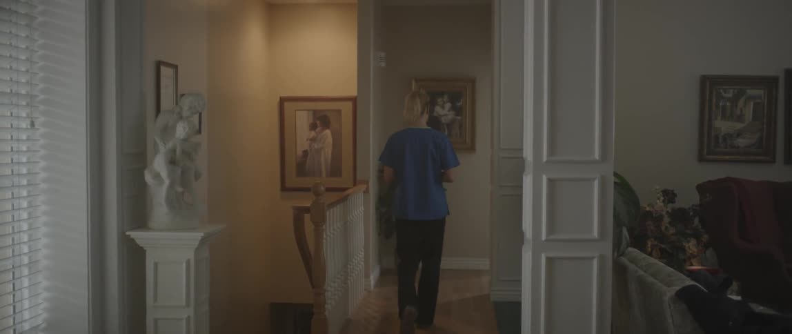 A woman walks down a hallway