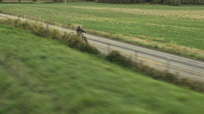 A footage of two motorcycles moving on the tarred road