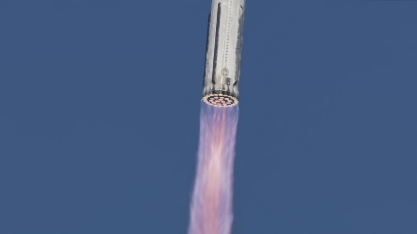 A rocket with a big purple flame at the bottom going up and the sky is blue