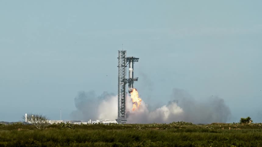 Rocket booster returns to the launch pad structure during a daytime vertical landing
