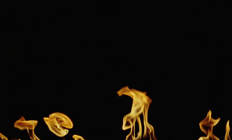 Golden fire flames against a dark background