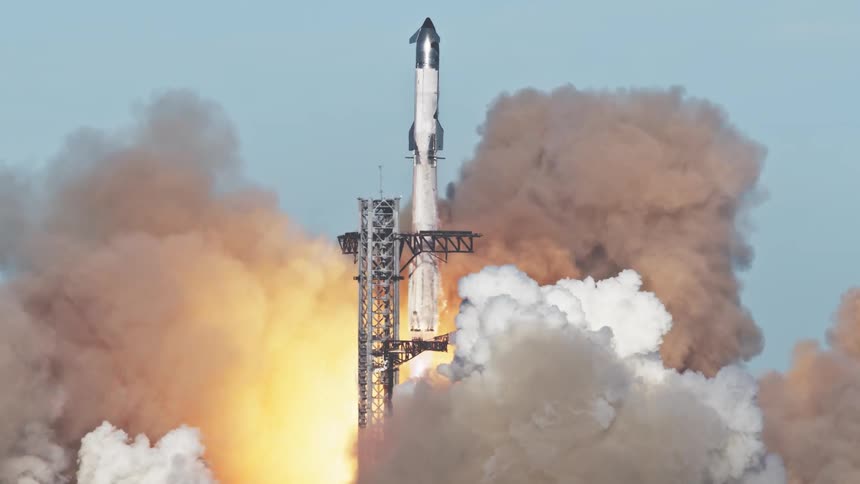 Rocket is launched from the platform releasing a large cloud of smoke and fire against a blue sky