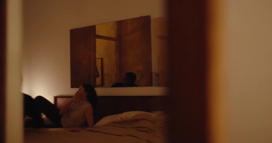 Woman and a man lying in bed and laughing