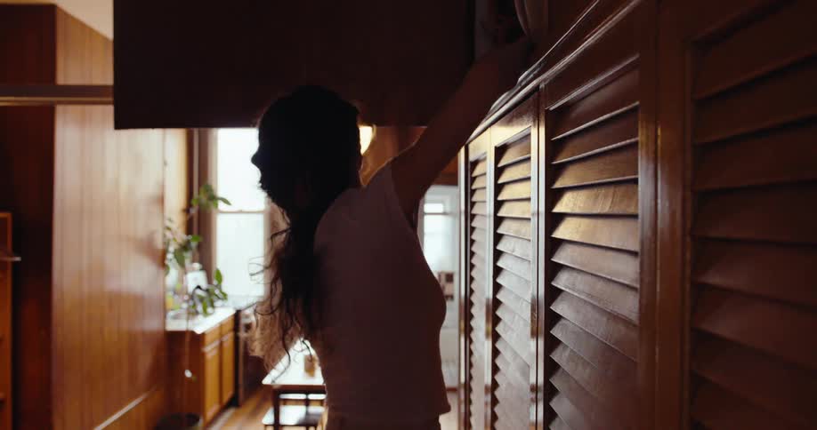 Woman organizing a wooden closet