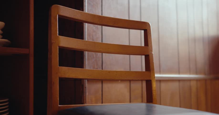 Wooden chair positioned next to a cabinet
